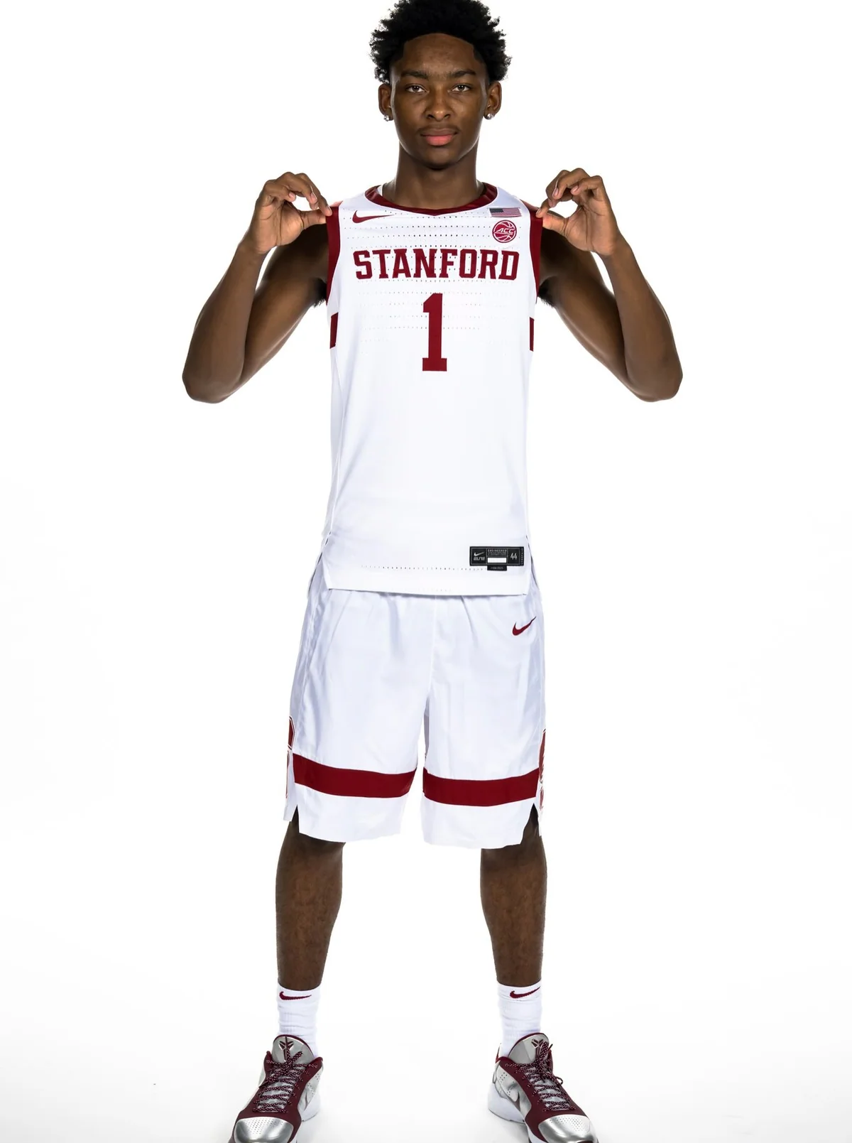 Kyi Kyi Miles holding a Stanford basketball jersey