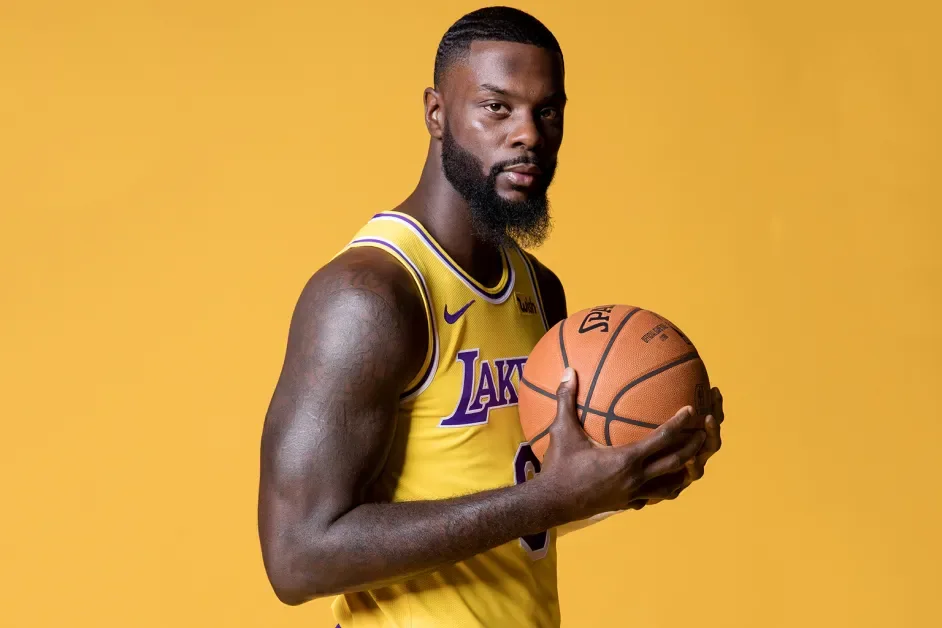 Lance Stephenson holding a basketball in a Los Angeles Lakers uniform
